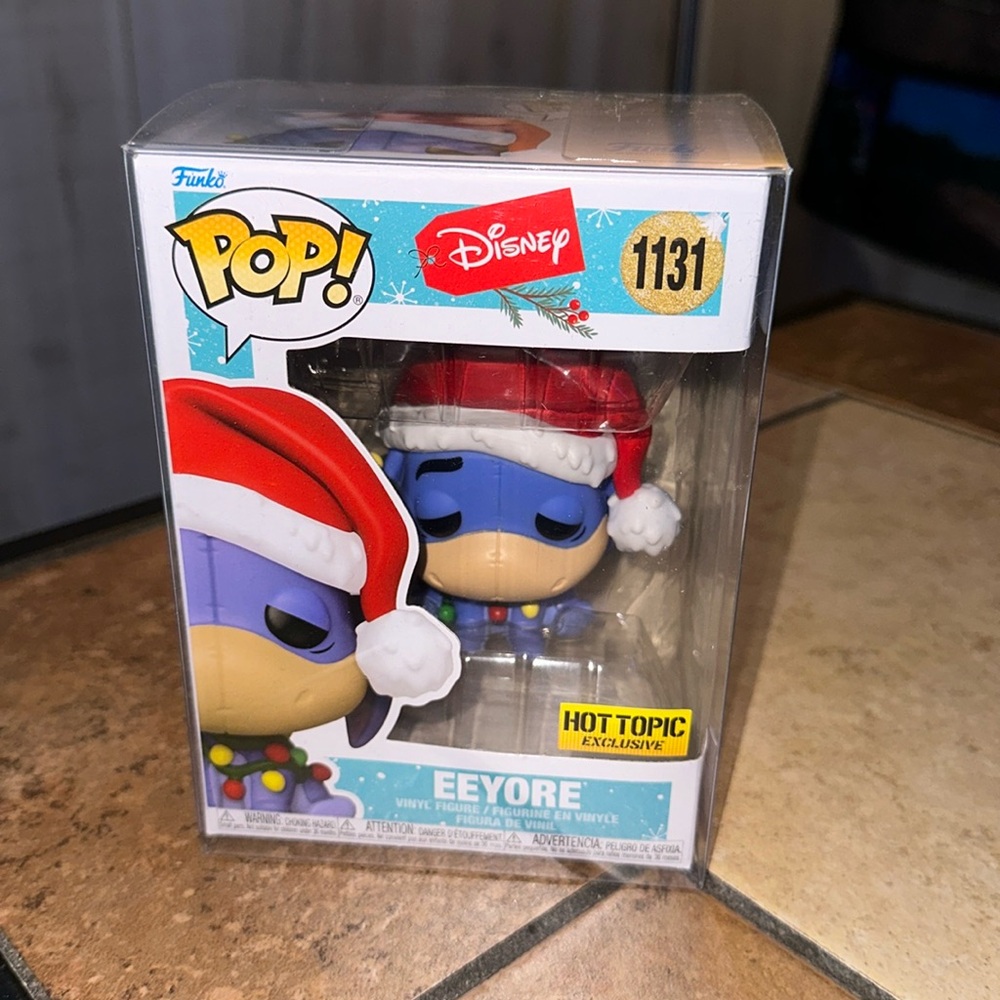 Christmas Eeyore Funko Pop with protective cover.
